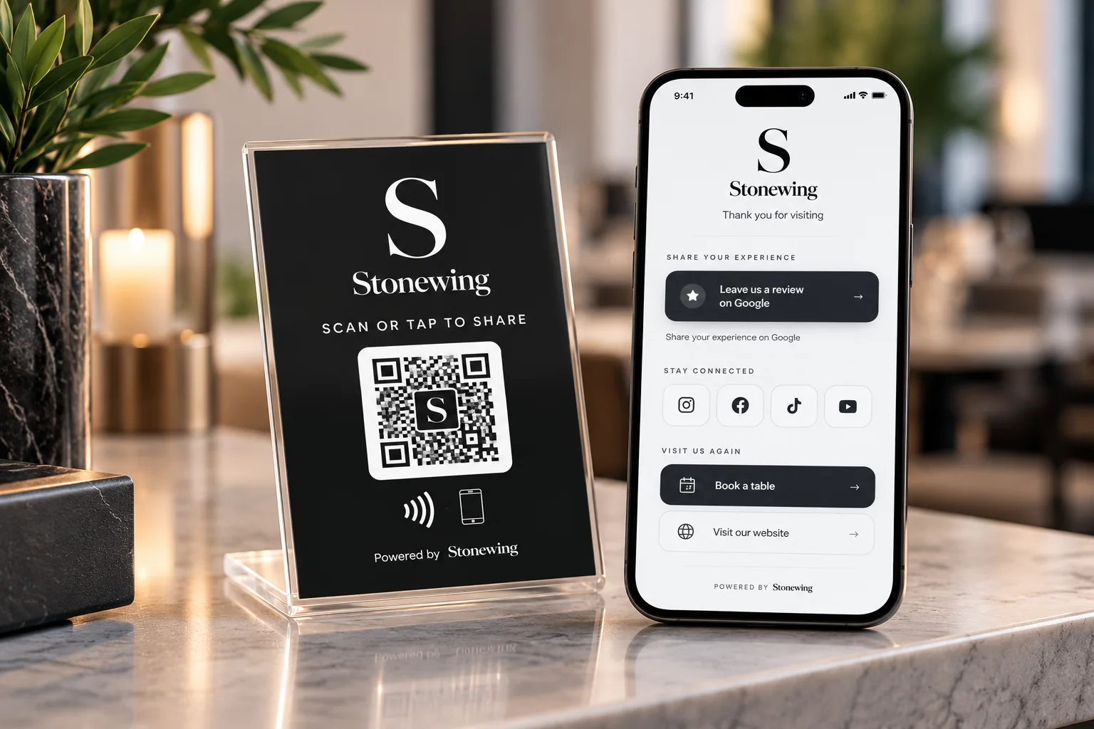 A Stonewing NFC and QR stand on a counter beside a smartphone showing a branded Stonewing customer page with review, social, booking and website links.
